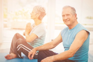 Portrait of smiling man sitting beside wife