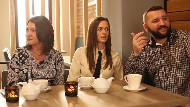 Businesspeople sitting in the cafe and having a quarrel
