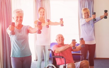 Portrait of seniors exercising with weights