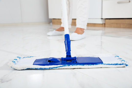 Woman Mopping The Floor In Kitchen