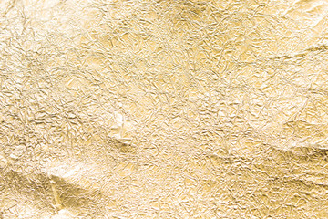 Gold wrinkled paper texture abstract background
