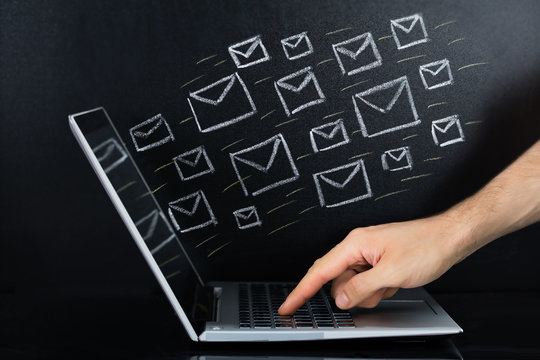 Person Hand Sending The Email From Laptop