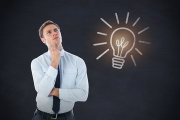 Composite image of thinking businessman with finger on chin