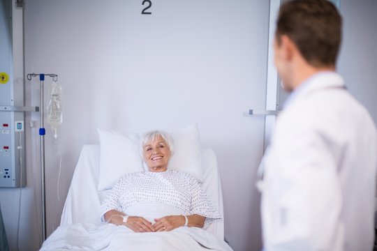 Doctors talking to a senior patient