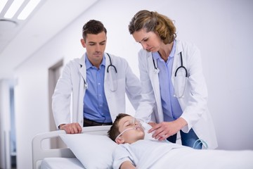 Doctors adjusting oxygen mask and rushing the patient