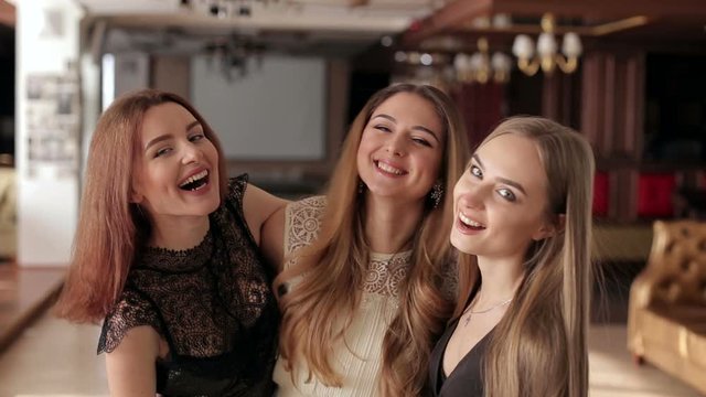Close-up of a group of laughing girls at the party.