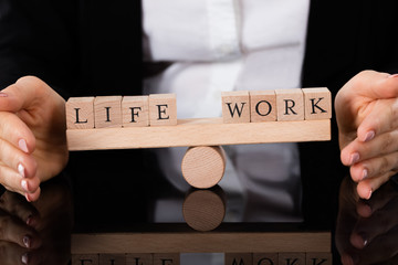 Life And Work Blocks Balancing On Seesaw