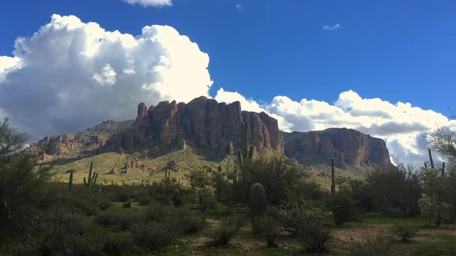 Arizona desert landscape with fluffy white clouds passing by. Time-lapse