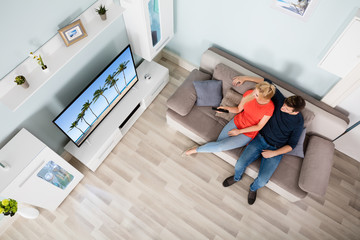High Angle View Of Couple Watching Television