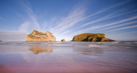 Wharariki beach, south new zealand at being high tide of sunrise