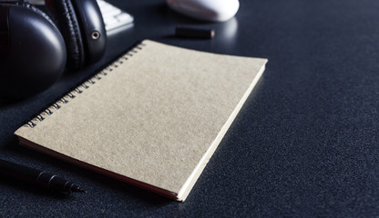 stationary and office equipment on wood table with film colors tone and soft-focus in the background. over light