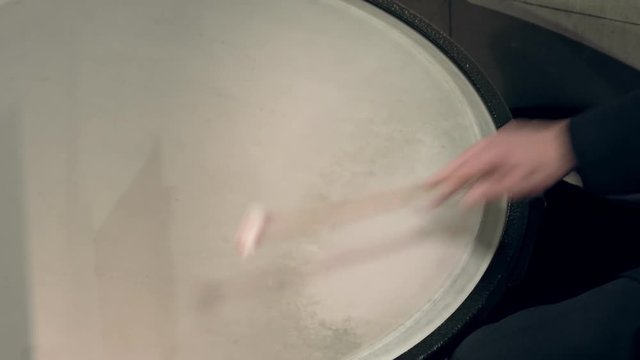 Timpanist plays the timpani at a classical music concert.
