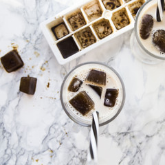 frozen coffee cubes with milk - cocktails on marble table