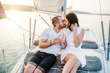 Young beautiful married couple in love at the yacht on vacation.