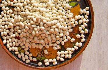 white beans in a beautiful wooden plate