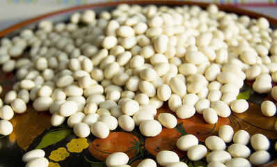 white beans in a beautiful wooden plate