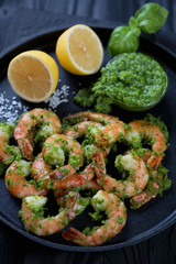 Tiger shrimps served with parsley sauce and lemon, closeup