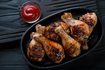 Above view of a frying pan with bbq chicken legs, close-up