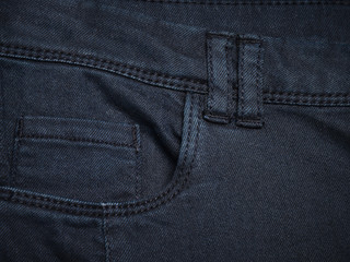 Fototapeta premium Navy blue denim textile for background closeup of pocket