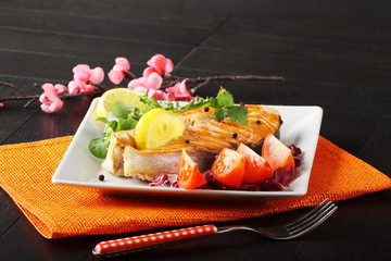 Slice of fresh salmon with tomatoes and salad