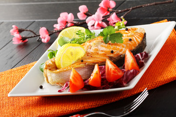 Slice of fresh salmon with tomatoes and salad - 134810826