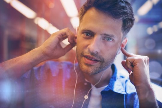 Portrait of handsome man listening music