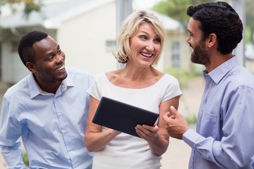 Fototapeta premium Business executives discussing over digital tablet