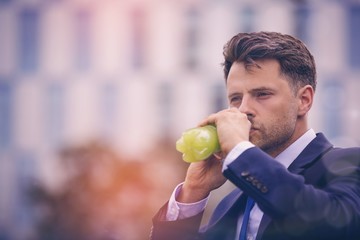 Close-up of businessman drinking juice