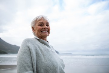 Fototapeta na wymiar Portrait of senior woman standing on the beach