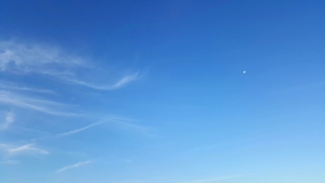 Clear blue sky with soft white cloud