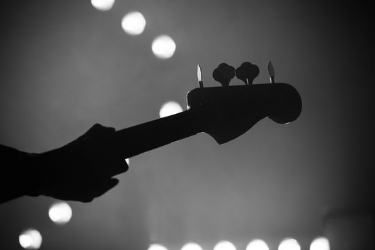 Bass guitar over blurred stage lights