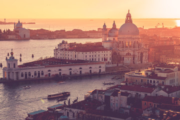 Aerial view of Venice, Italy, at sunset with rooftops of buildings and vintage colors in winter sunset.