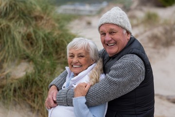 Fototapeta premium Happy senior couple standing together on the beach