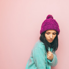 Girl with beautiful face stands in a fashion pose. pastel color mix. stylish swag and minimal. winter clothing. 