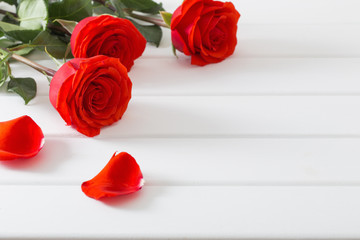 red rose on white wooden table