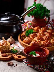 Ukrainian borsch and dumplings with garlic on the table