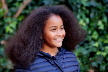 Pretty girl with long afro hair in the garden