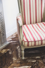 Vintage striped chair on old wooden floor