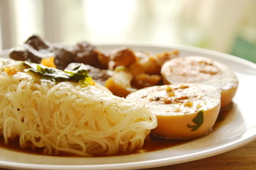 thin rice noodle with pork entrails and tofu topping egg on dish