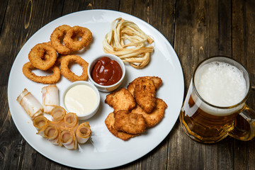 Beer in a glass on wooden background. and snack.