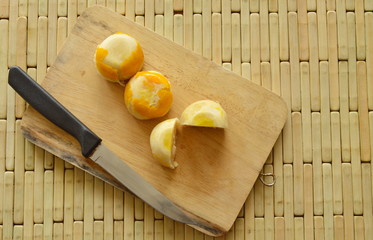 Chinese cake stuffed mashed bean and salty egg yolk on wooden chop plate