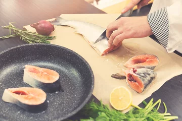 Papier Peint photo Lavable Poisson seafood - chef slicing salmon fish for preparing