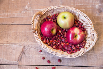 Wicker basket is dried rosehips and three apples