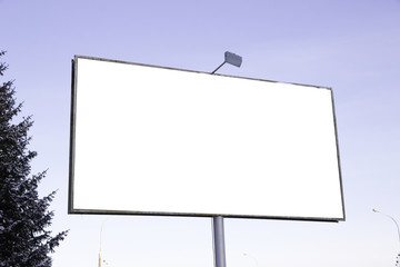Empty billboard for outdoor advertising backlight against sky