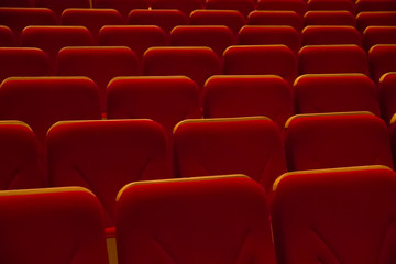Rows of red chairs in movie theater