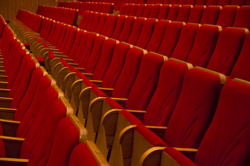Empty red chairs in movie theater without people