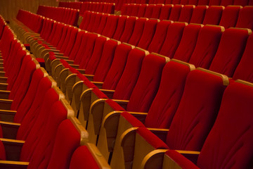 Fototapeta premium Empty red chairs in movie theater without people