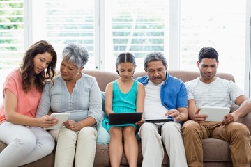 Multi-generation family using digital tablet in living room