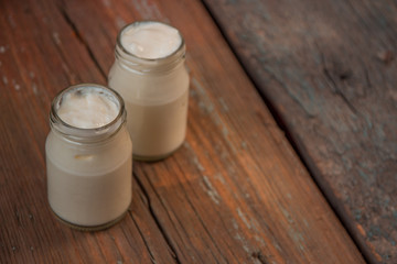 Yogurt in jar on the wooden table