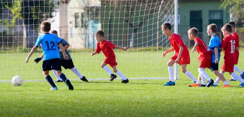 Foto op Plexiglas  Boys kicking ball © Dusan Kostic